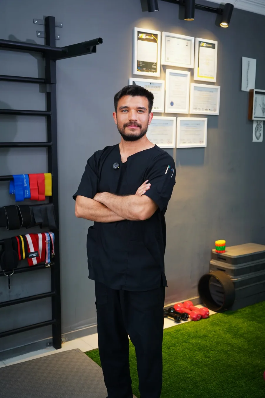 The clinic: wall bars, resistance bands, plyometric boxes and the certificate wall.